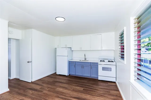 a view of a kitchen with wooden floor