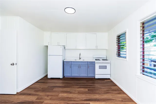 a kitchen with wooden floors and sink