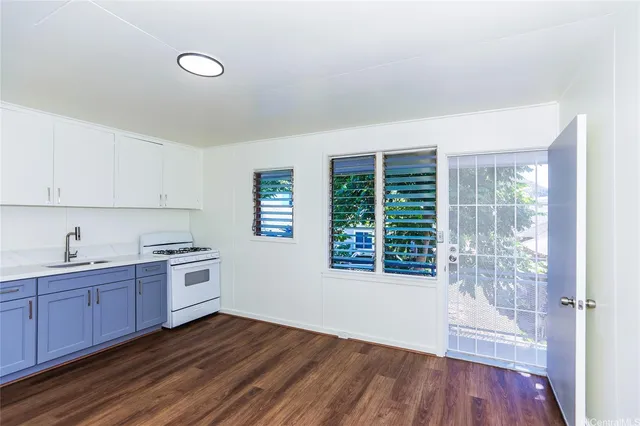 a view of a kitchen with wooden floor and electronic appliances