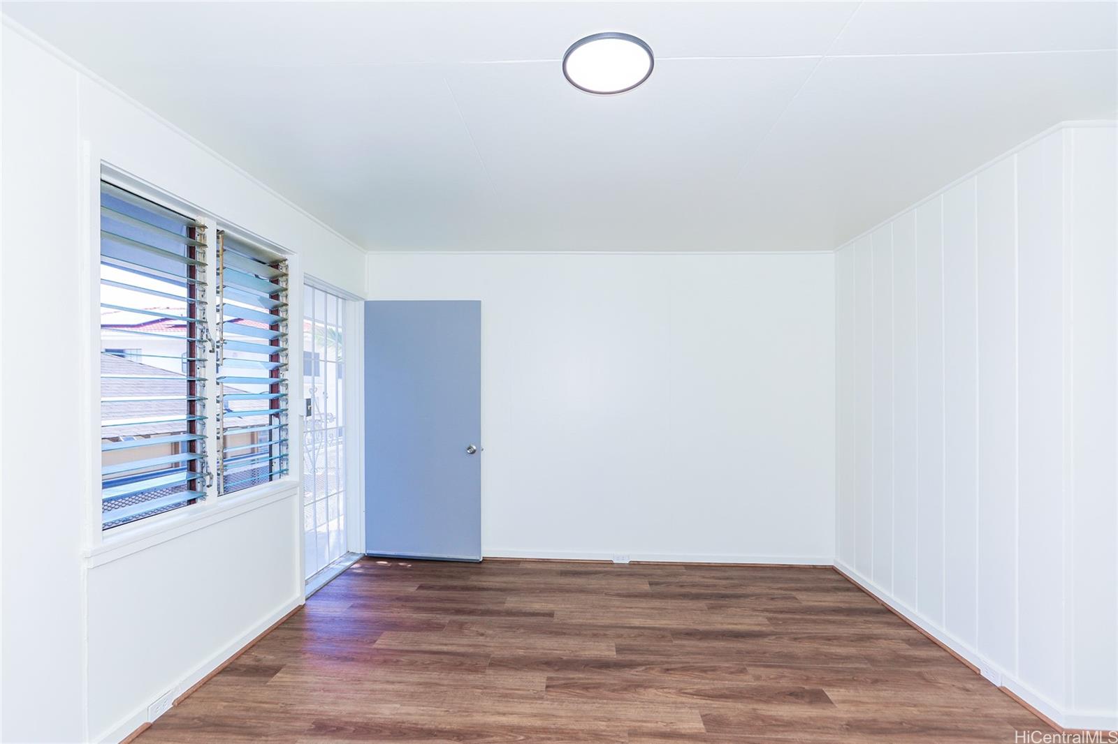 1719 Nuuanu Avenue, Unit 5F Honolulu, HI 96817 - Photo 10 of 25 a view of an empty room with window and wooden floor