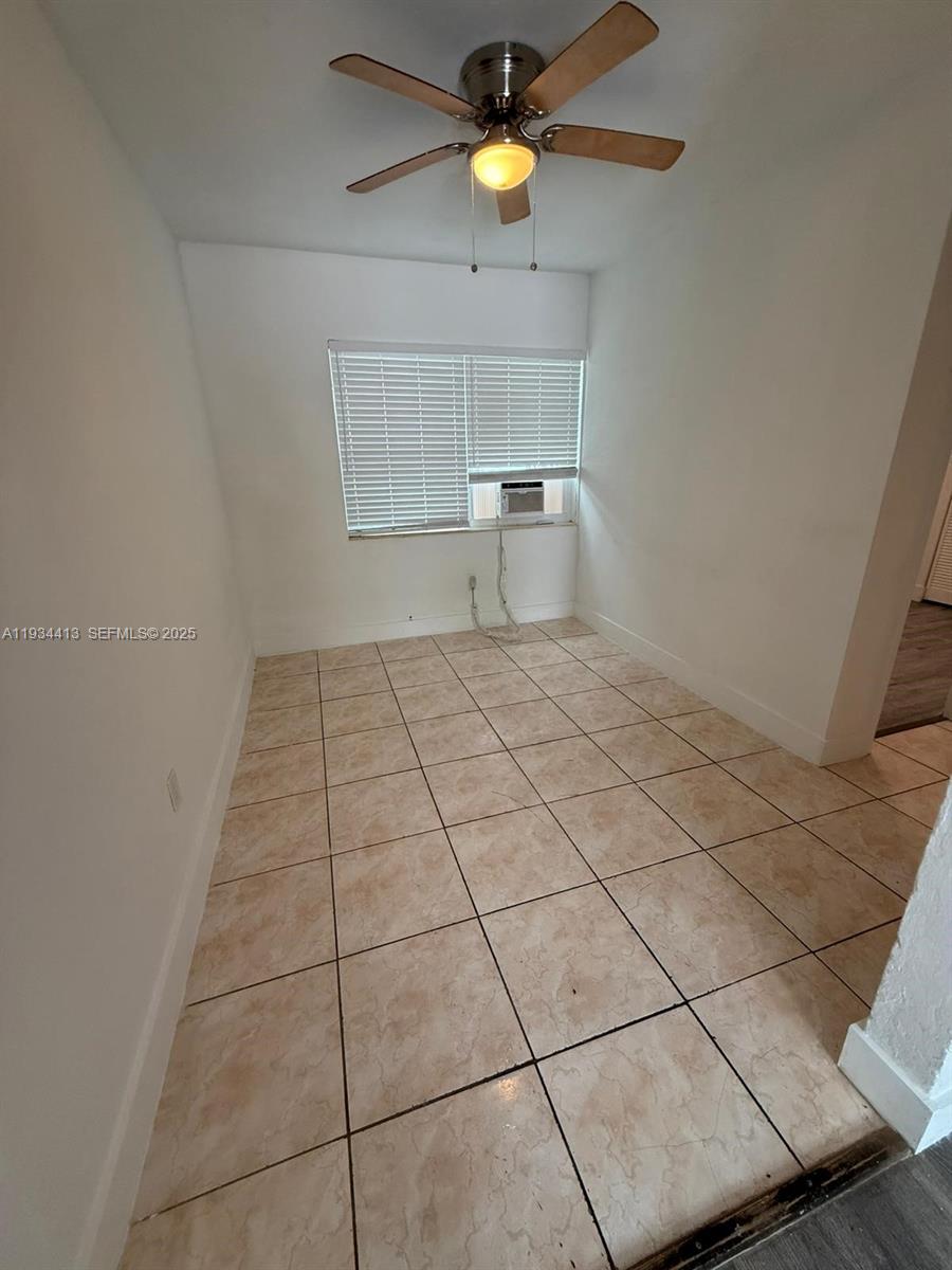 6909 Northwest 2nd Avenue, Unit 6909 Miami, FL 33150 - Photo 2 of 9 a view of an empty room and window and chandelier fan