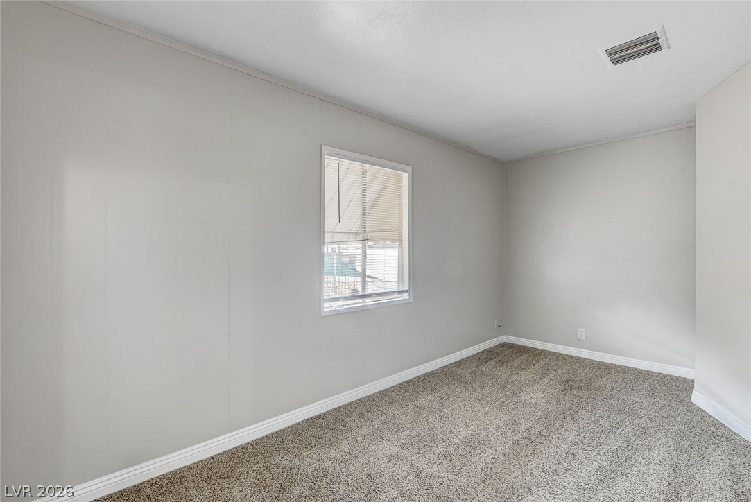 214 West Victory Road Henderson, NV 89015 - Photo 20 of 33 Comfortable carpeted flooring awaits in this naturally illuminated room.