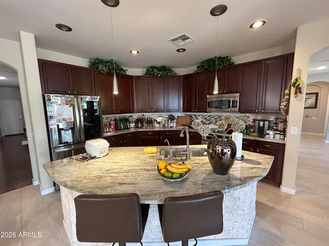 a kitchen with a dining table and chairs