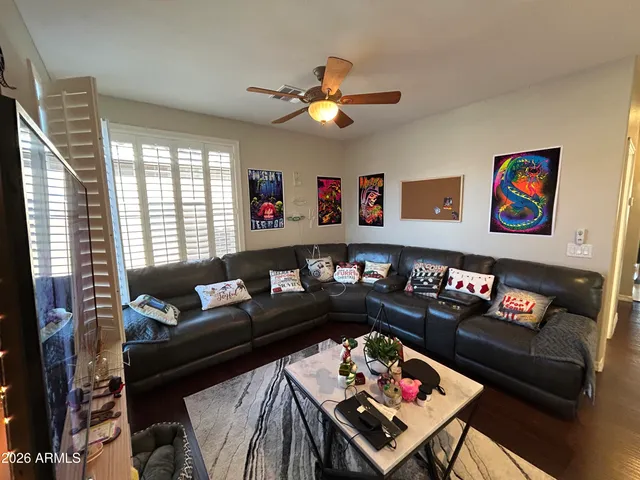 a living room with furniture and a bookshelf