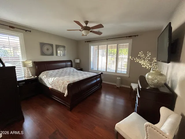 a bedroom with a bed and wooden floor