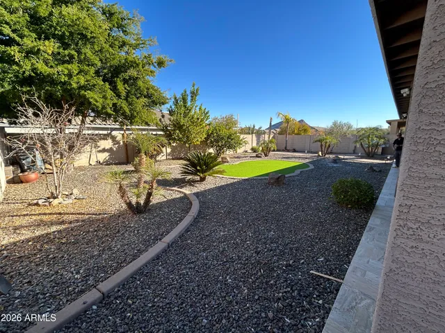 a view of a yard with wooden fence