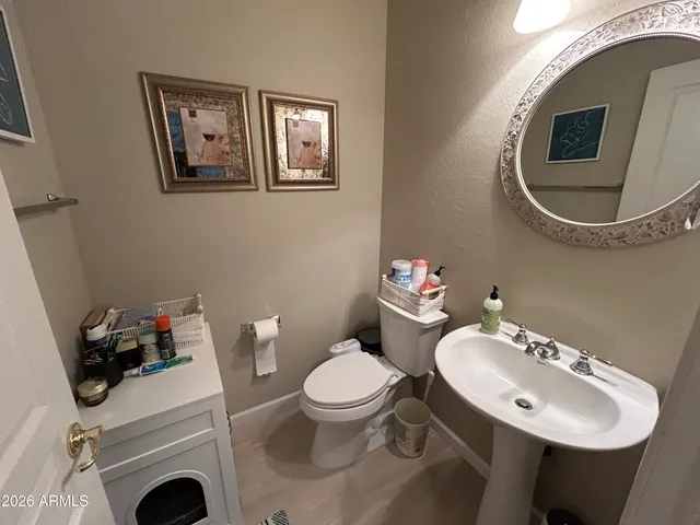 a bathroom with a toilet a sink and mirror