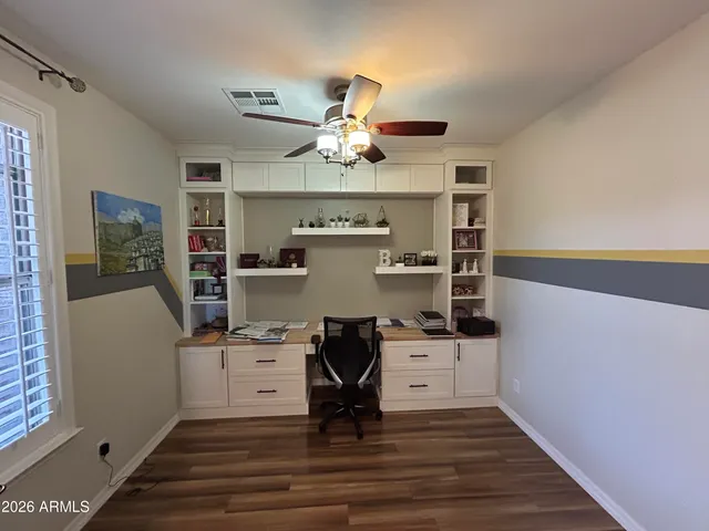 a view of workspace with wooden floor and ceiling fan