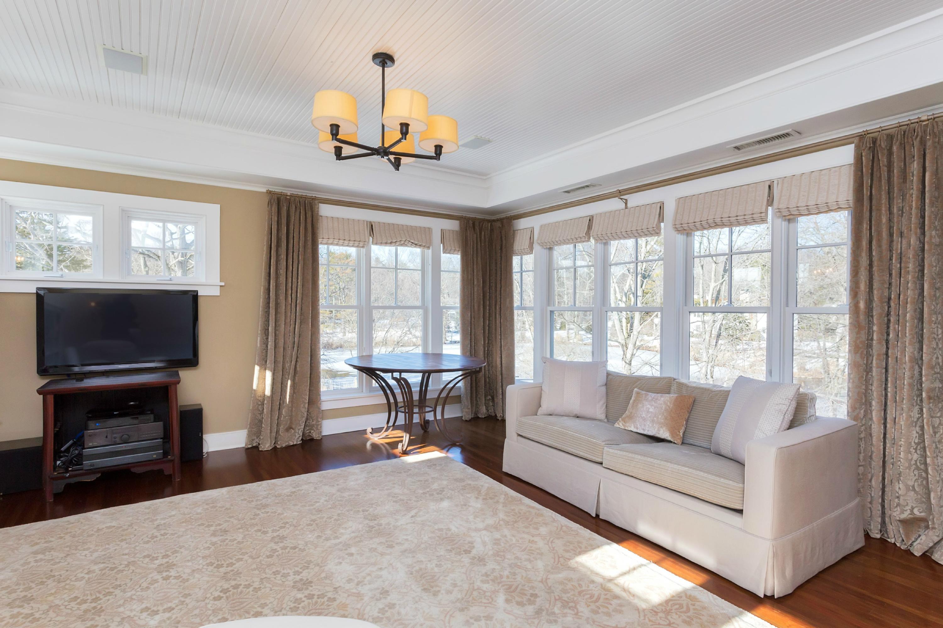 39 Old Farm Road Darien, CT 06820 - Photo 23 of 36 a living room with furniture a flat screen tv and a large window