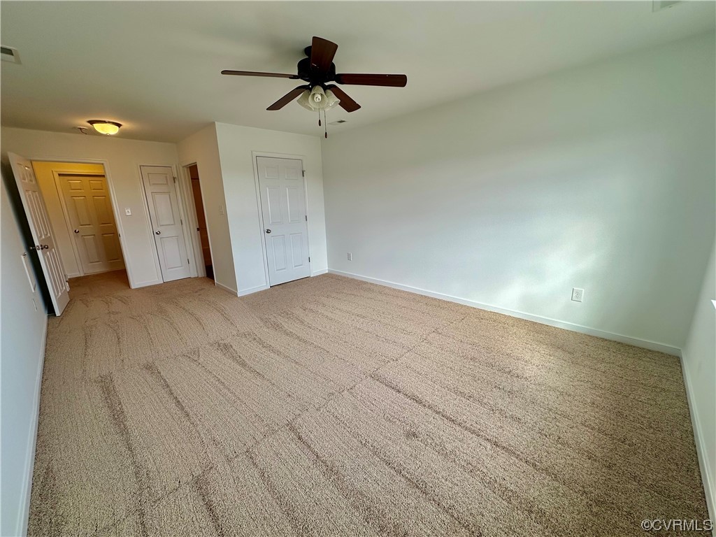 3314 Kennington Park Road Aylett, VA 23009 - Photo 22 of 36 an empty room with a ceiling fan and hardwood