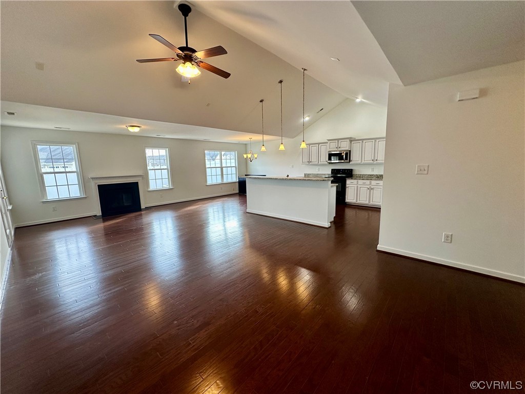 3314 Kennington Park Road Aylett, VA 23009 - Photo 3 of 36 a view of an empty room and kitchen with wooden floor