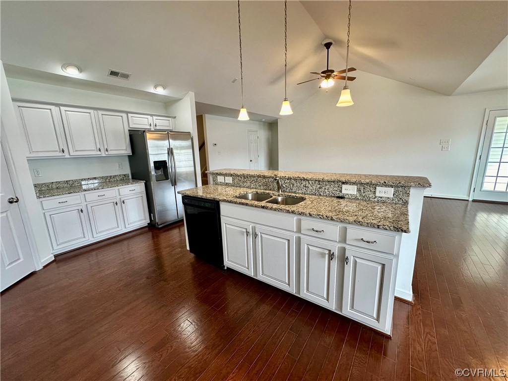 3314 Kennington Park Road Aylett, VA 23009 - Photo 9 of 36 a kitchen with stainless steel appliances granite countertop wooden floors and white cabinets