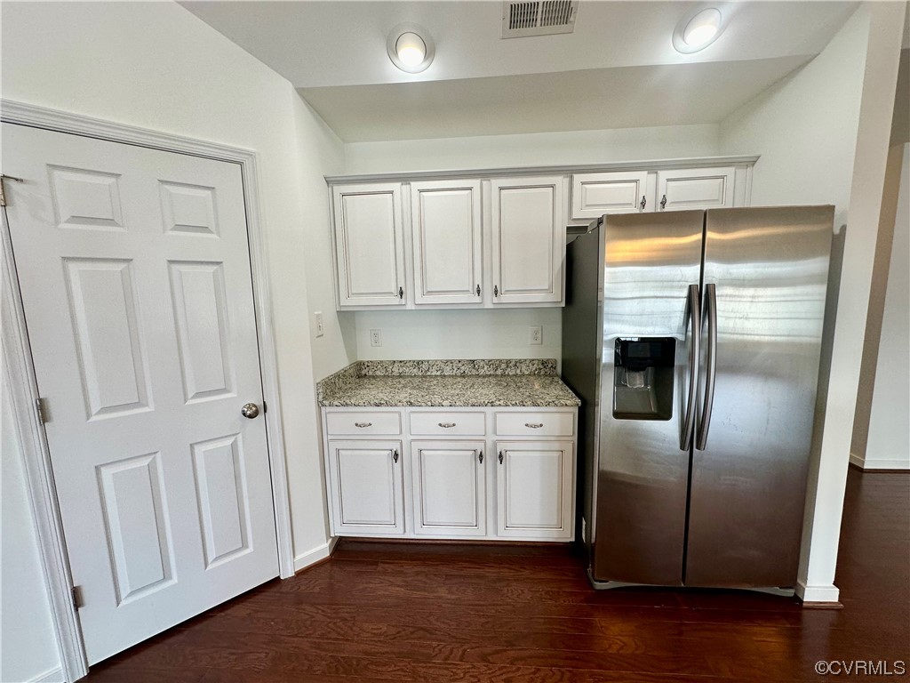 3314 Kennington Park Road Aylett, VA 23009 - Photo 10 of 36 a kitchen with granite countertop a refrigerator a sink and white cabinets