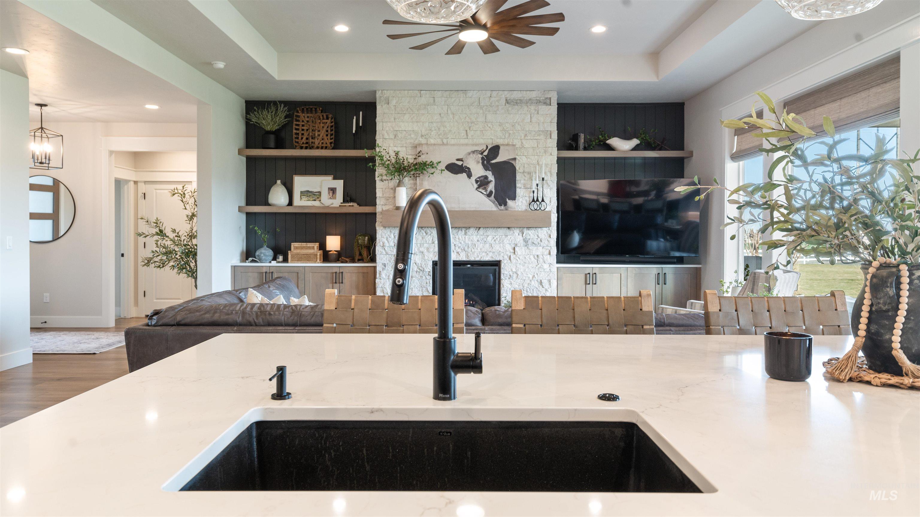 16901 Spring Meadow Drive Caldwell, ID 83607 - Photo 22 of 50 Living room with a raised ceiling, wood finished floors, a fireplace, recessed lighting, and built in features
