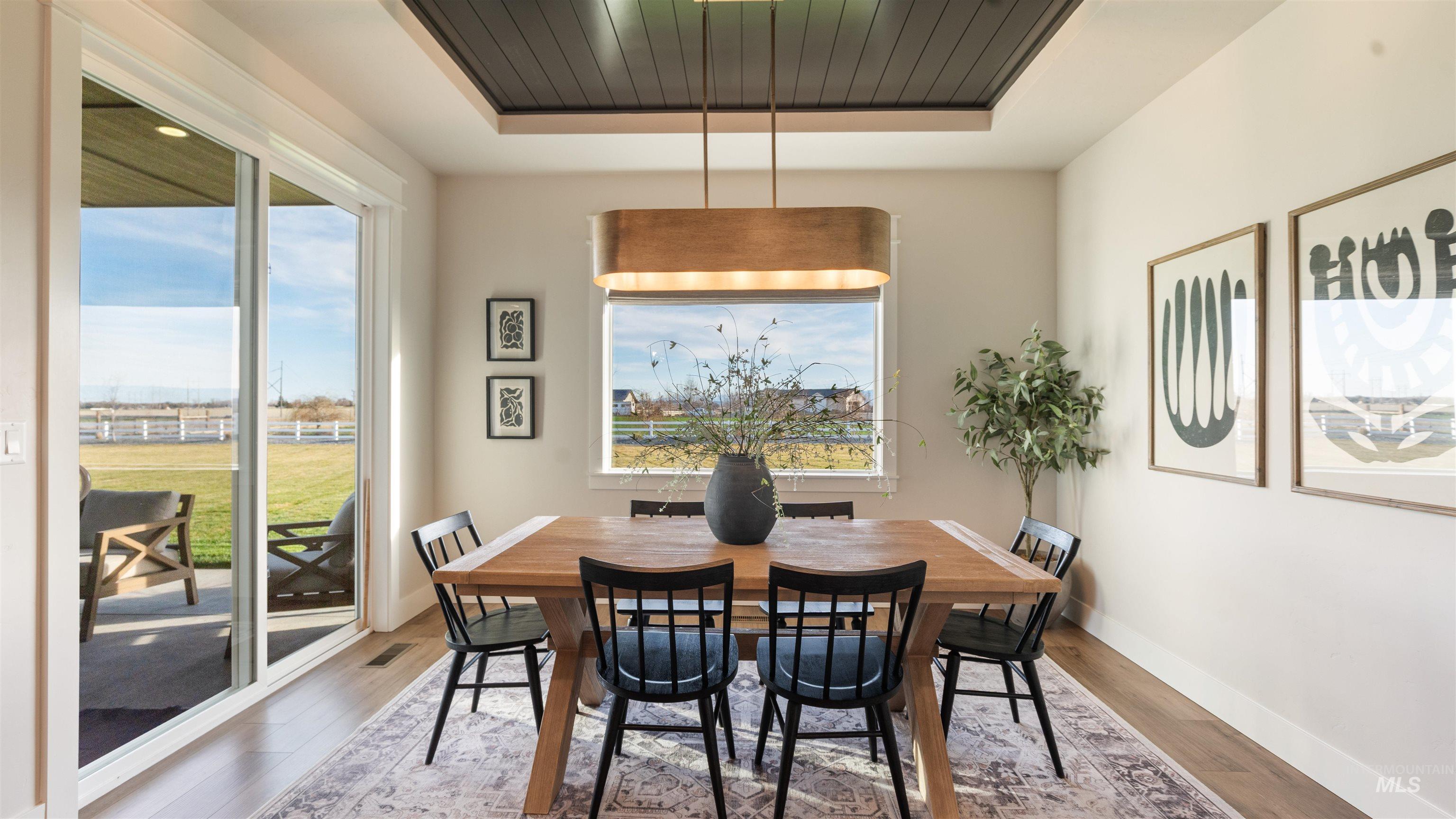16901 Spring Meadow Drive Caldwell, ID 83607 - Photo 24 of 50 Dining room featuring a raised ceiling and wood finished floors
