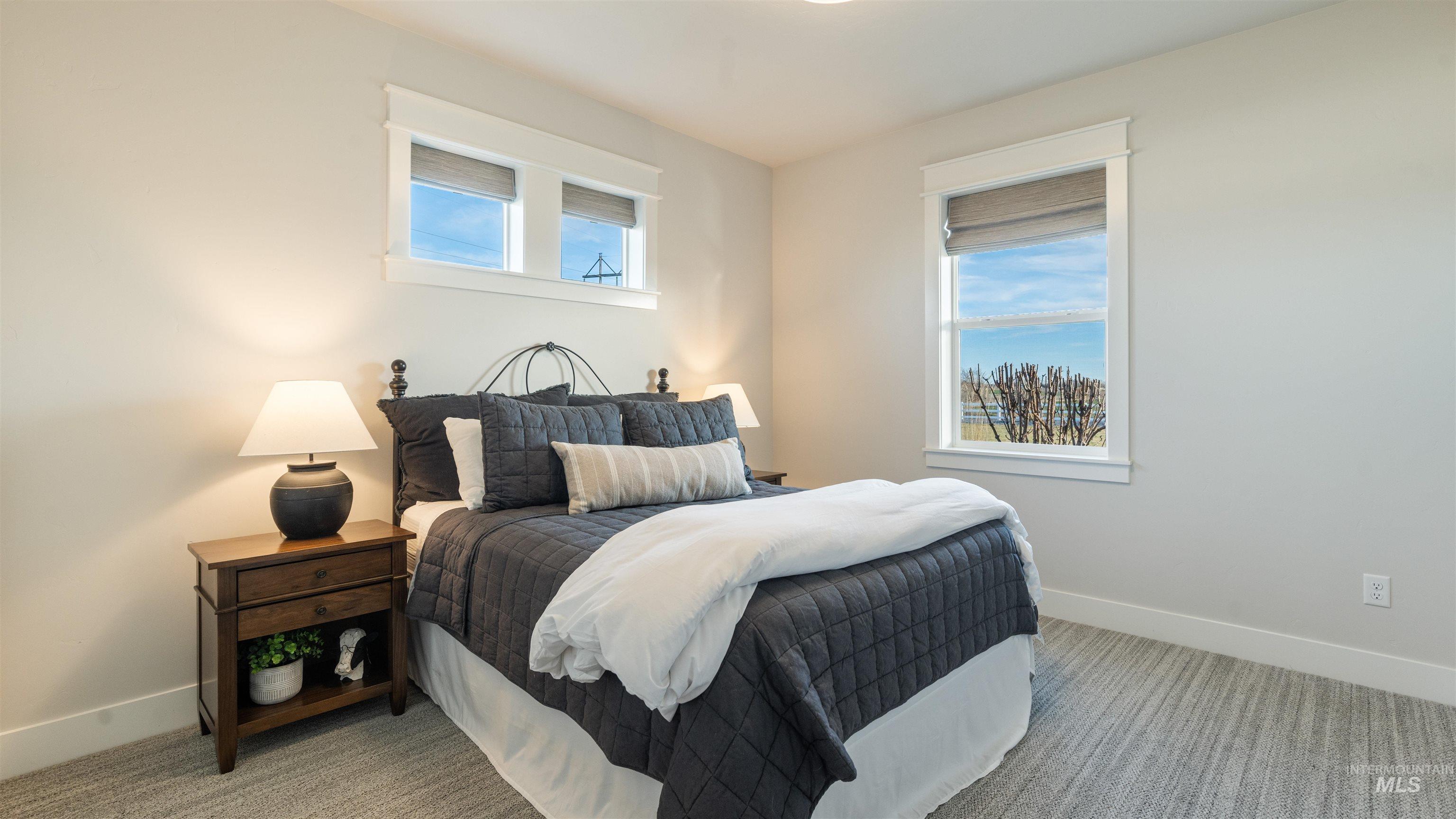 16901 Spring Meadow Drive Caldwell, ID 83607 - Photo 29 of 50 Bedroom featuring multiple windows and light carpet