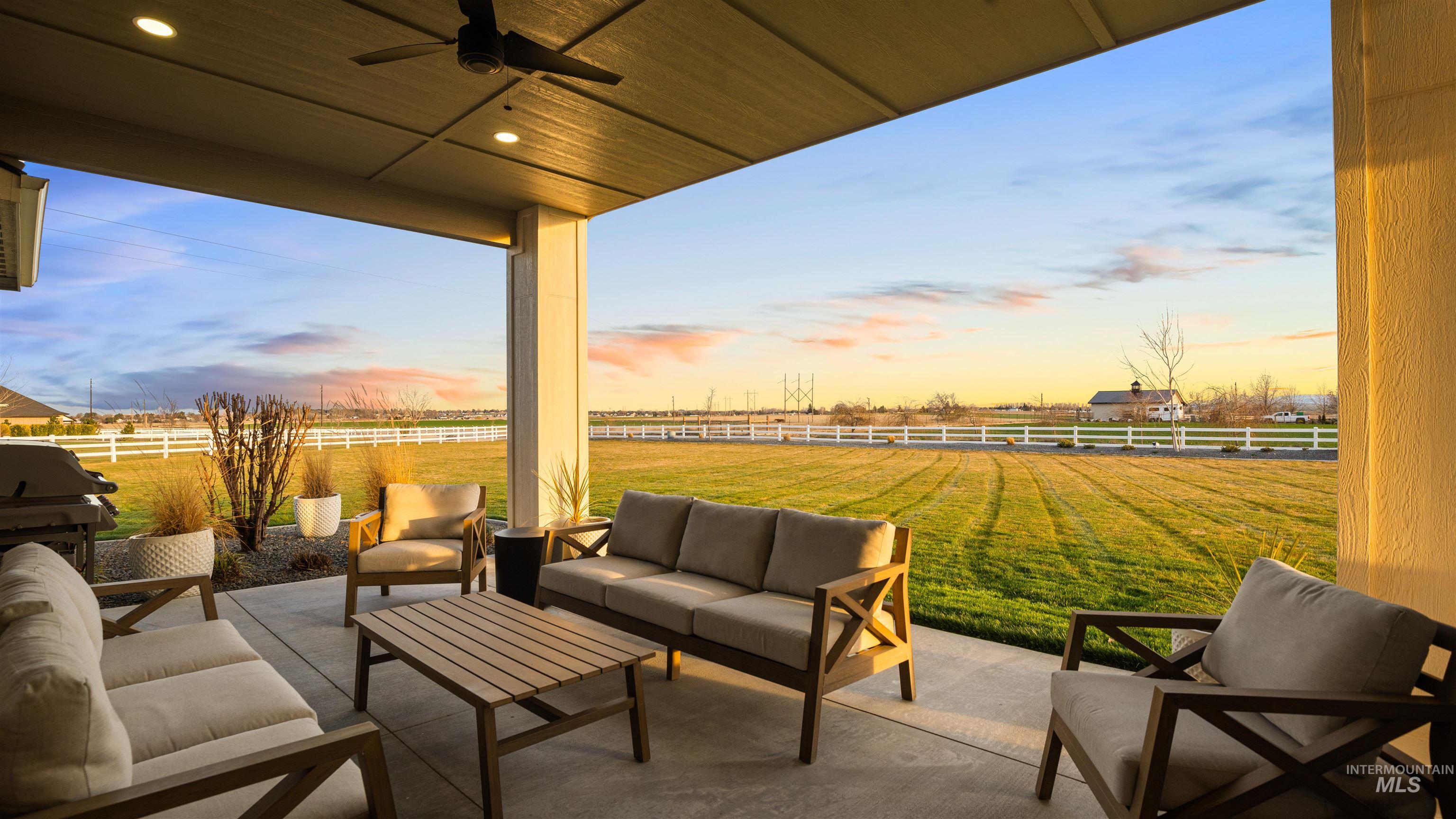 16901 Spring Meadow Drive Caldwell, ID 83607 - Photo 7 of 50 Fenced backyard with outdoor furniture, a patio, a ceiling fan, and grilling area