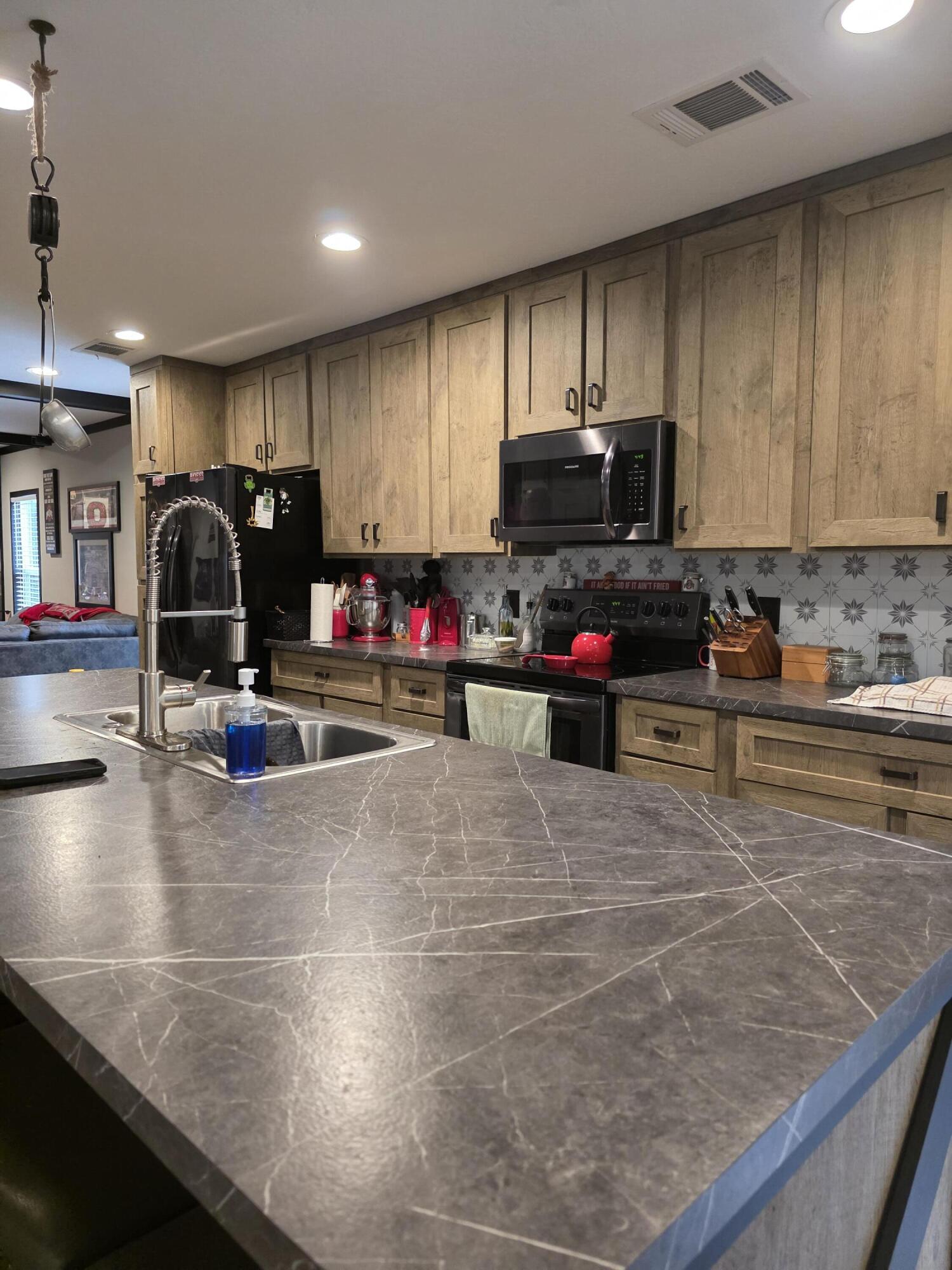 4320 Highway 79 Vernon, FL 32462 - Photo 13 of 49 a kitchen with kitchen island granite countertop a sink and a stove