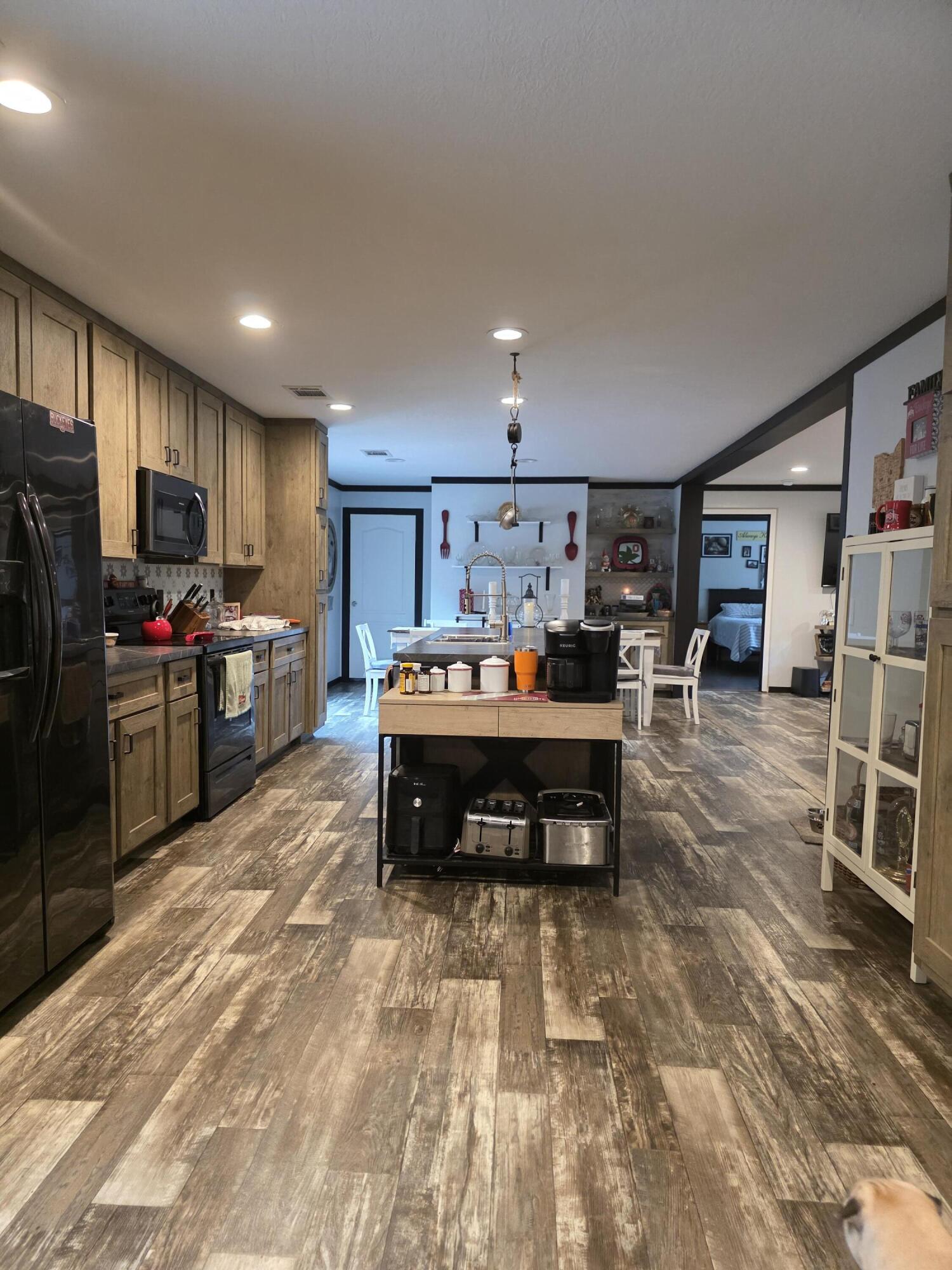 4320 Highway 79 Vernon, FL 32462 - Photo 19 of 49 a kitchen with stainless steel appliances kitchen island granite countertop a refrigerator and a stove top oven