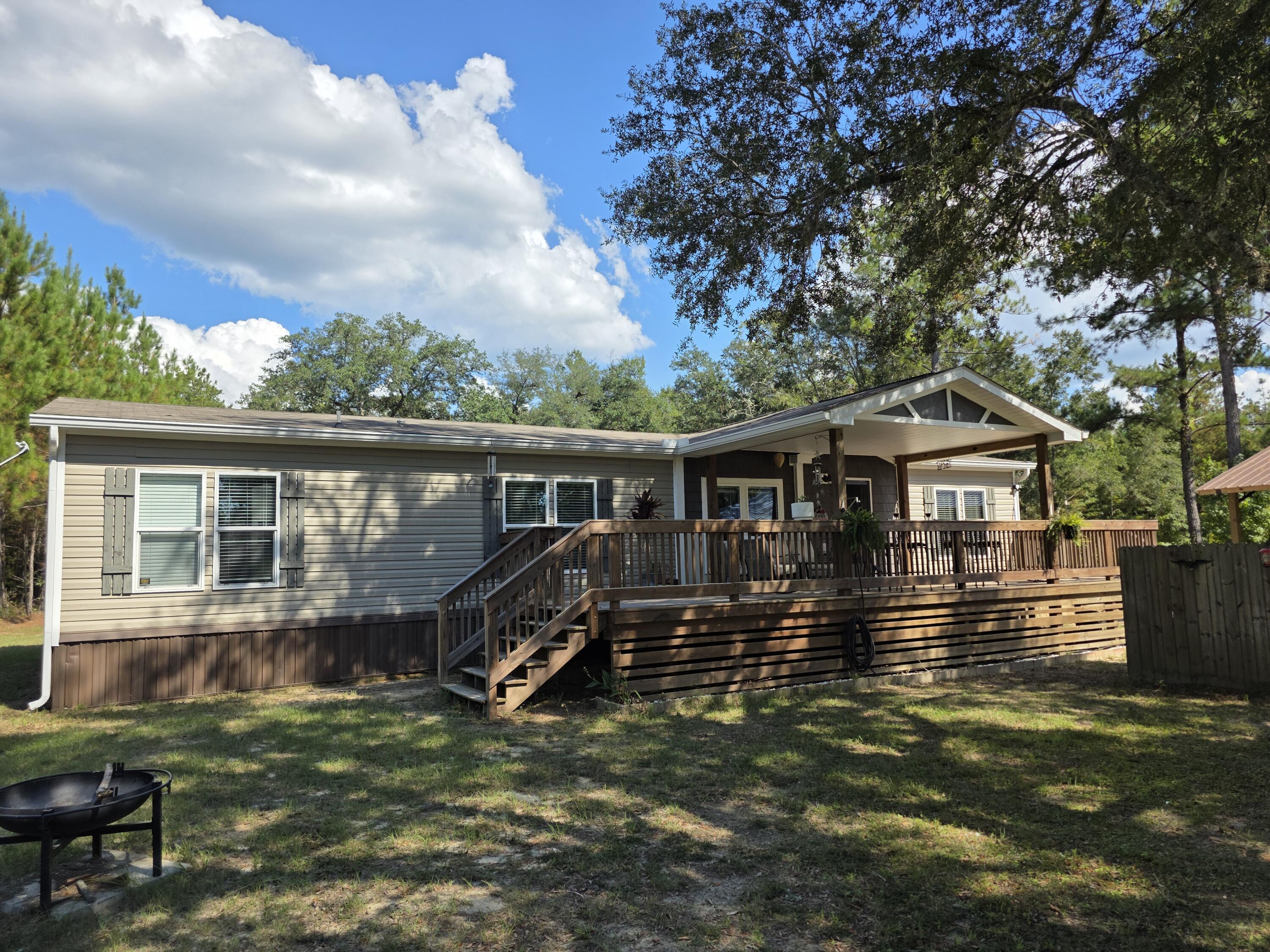 4320 Highway 79 Vernon, FL 32462 - Photo 2 of 49 a house that has tree in front of it