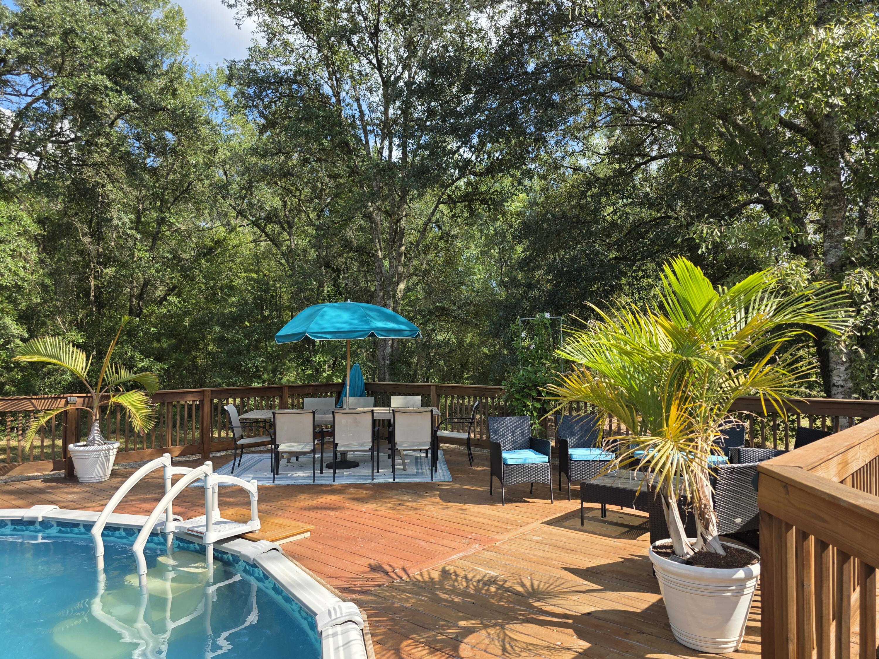 4320 Highway 79 Vernon, FL 32462 - Photo 35 of 49 a view of a swimming pool with chair and table