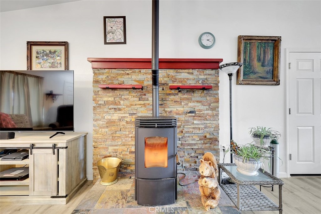 14141 Racine Circle Magalia, CA 95954 - Photo 12 of 53 a living room with furniture a flat screen tv and a fireplace