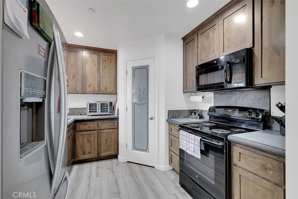 14141 Racine Circle Magalia, CA 95954 - Photo 14 of 53 a kitchen with stainless steel appliances granite countertop a stove top oven a sink and a refrigerator