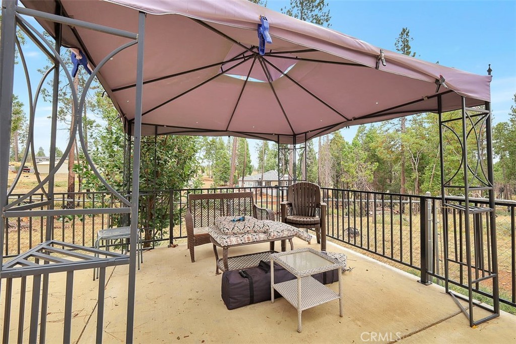 14141 Racine Circle Magalia, CA 95954 - Photo 36 of 53 a view of a patio with a table and chairs under an umbrella