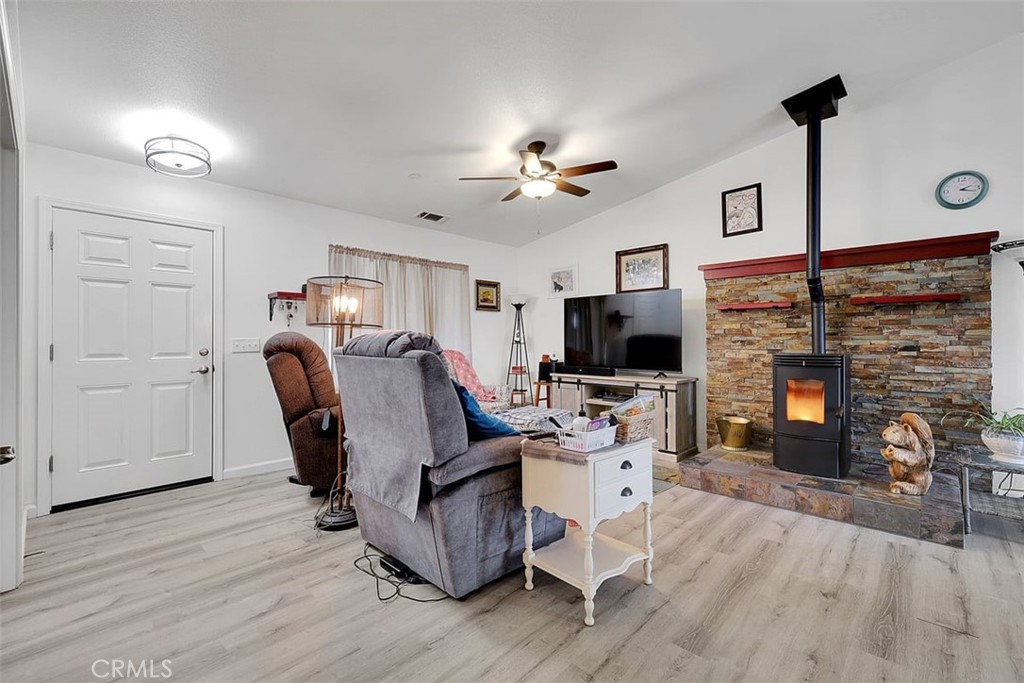 14141 Racine Circle Magalia, CA 95954 - Photo 9 of 53 a living room with furniture a fireplace and a flat screen tv