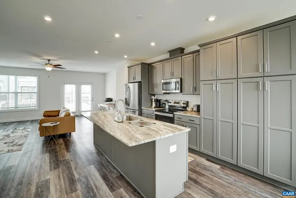 a kitchen with sink refrigerator and microwave