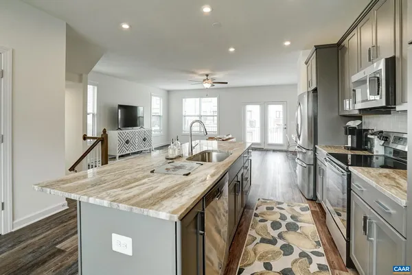 a kitchen with a stove a sink and a refrigerator