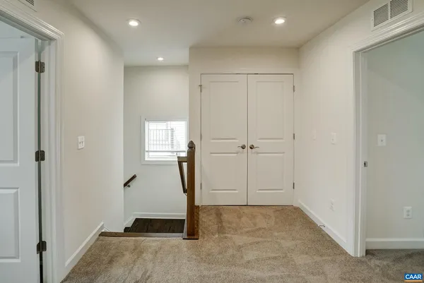 a view of a livingroom with a projector and kitchen space
