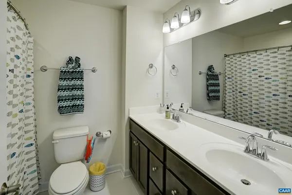 a bathroom with a sink toilet and a mirror