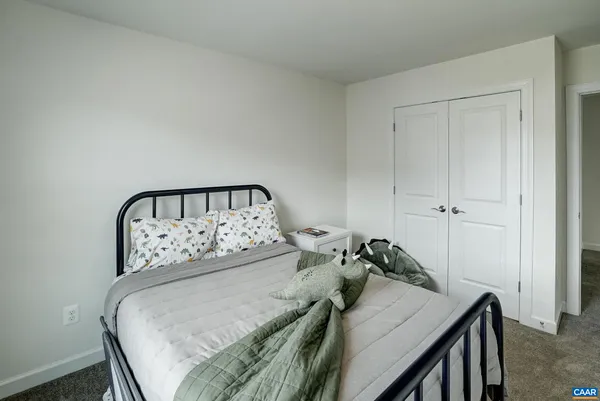 a bed sitting in a bedroom next to a window