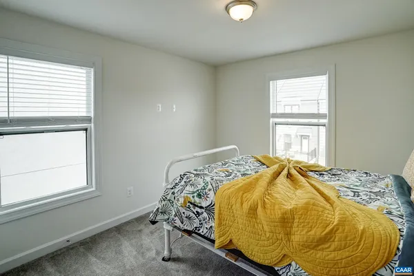 a bed sitting in a bedroom next to a window