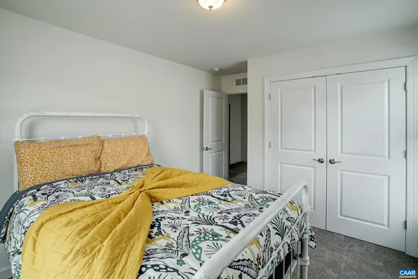 a bedroom with a bed and a closet