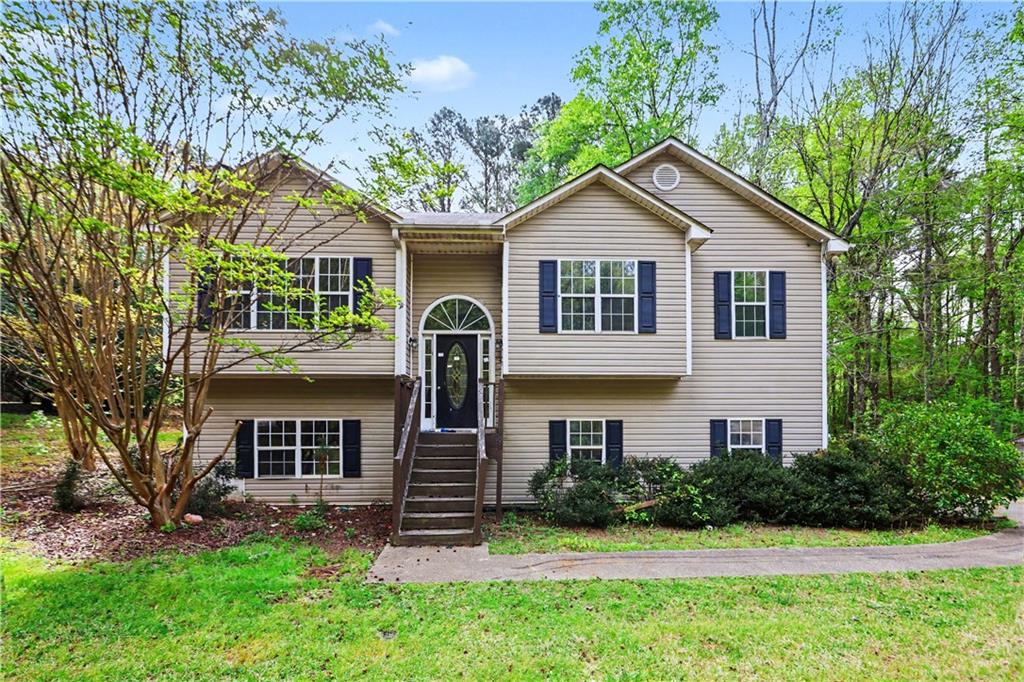 706 Bar J Road Temple, GA 30179 - Photo 1 of 1 a front view of a house with a yard and trees