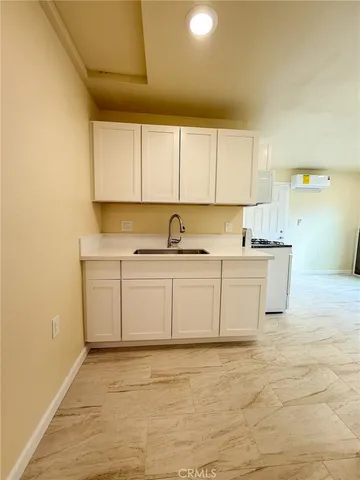 a view of a kitchen with sink and cabinets