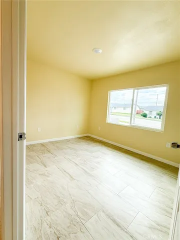 an empty room with a empty space and window