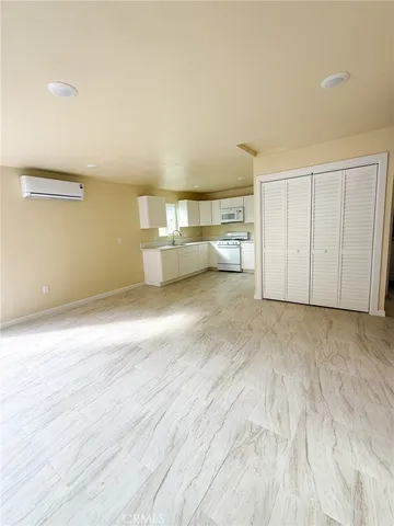 a view of a livingroom with an empty space and a window