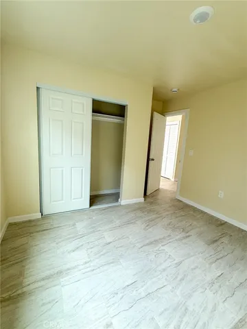 a view of an empty room and wooden floor