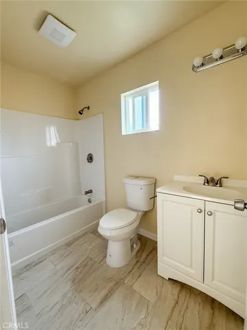 a bathroom with a toilet a sink and bathtub