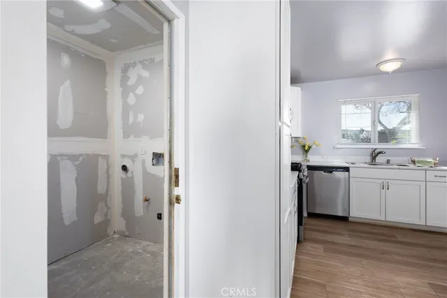a kitchen with a refrigerator and a stove top oven