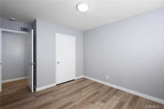 a view of hallway with wooden floor