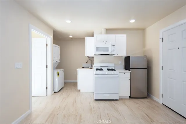 a view of a room with wooden floor and a window