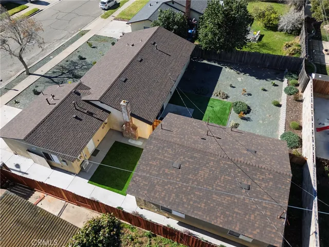 an aerial view of a house with a yard