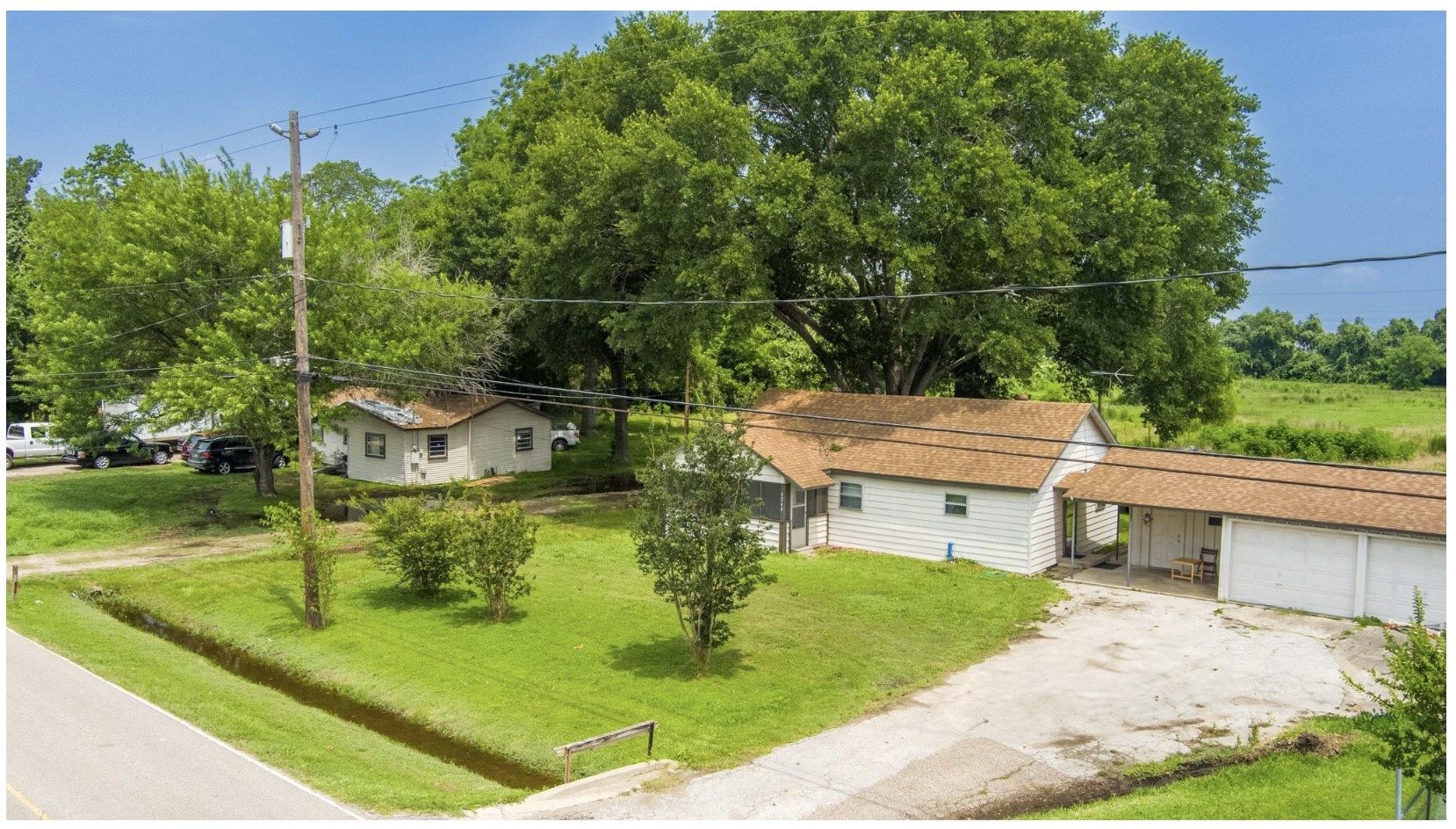 3240 Brownie Campbell Road Houston, TX 77086 - Photo 18 of 19 a view of a patio with table and chairs potted plants and large tree