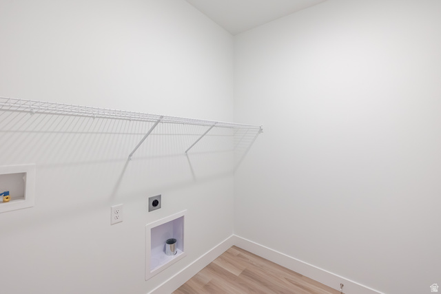 675 West 4500th South, Unit P201 Mapleton, UT 84664 - Photo 4 of 16 Dedicated laundry room featuring light wood-finish flooring, white walls, and a wire shelving unit