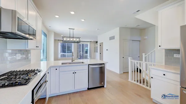 a kitchen with stainless steel appliances granite countertop a stove and a refrigerator