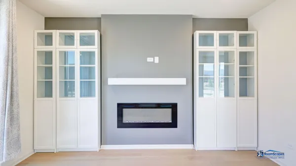 a living room with a fireplace and windows